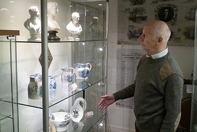 Peel Society chairman Robert Critchley inspecting one of the new display cases. 